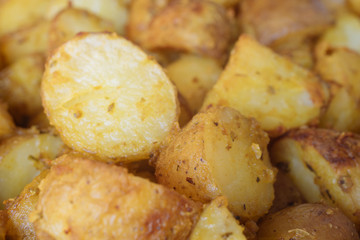 Closeup on baked potatoes with curcuma and other spices