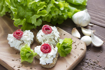 Obraz na płótnie Canvas Cream cheese sandwiches with salami and salad leaves,healthy food.