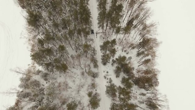 Winter off-road racing side-by-side vehicles. Aerial view: Rally on the buggy on the snow on a winter day. Racing in the SXS class. Buggy, sports car on rally. Off Road Series racing. 4K video, drone