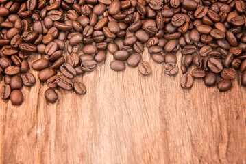 Coffee beans on grunge wooden background