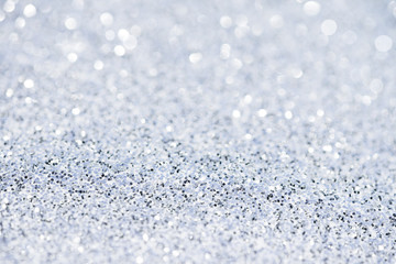 Silver white glittering Christmas lights. Blurred abstract background