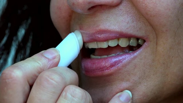details of lipstick on mature lips of Caucasian woman with Arabic and Middle Eastern somatic traits