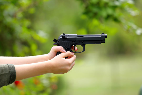 Young girl practice shooting guns on outdoor