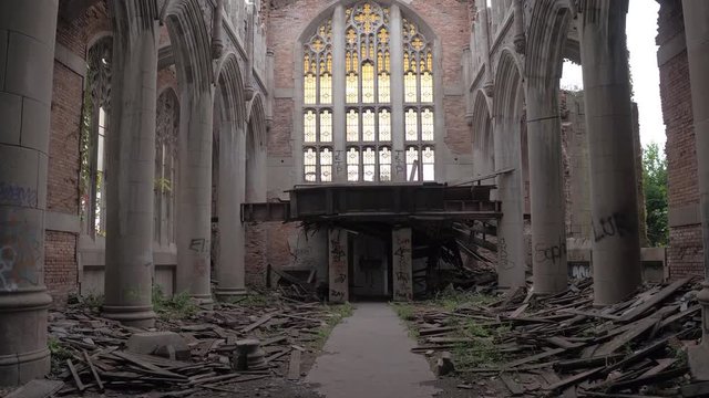 CLOSE UP: Exploring ruins of stunning crumbling sanctuary in abandoned City Methodist Church, USA. Beautiful old religious building with stunning architectural features, columns, adornments collapsing