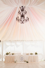 Marquee for the celebration of the wedding. Beautiful white interior with white draperies