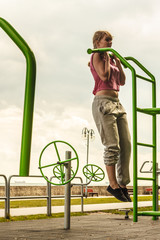 Fototapeta premium Active woman exercising on ladder outdoor.