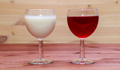 Glasses with wine and milk