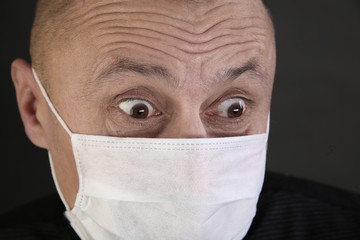 man in a black T-shirt and a medical mask