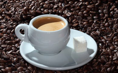 cup of coffee on the background of coffee beans