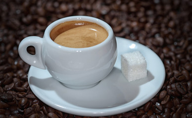 cup of coffee on the background of coffee beans