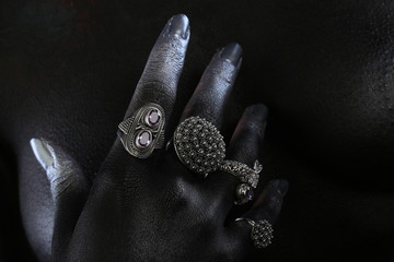 Silver jewelry on a dark background