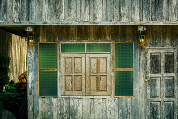 A vintage door and window on the wooden wall
