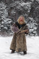 Lumberjack in the winter pine forest