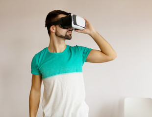 Young bearded man wearing virtual reality.