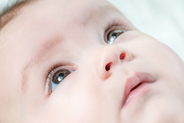 Face of a cute baby with brown eyes, close-up