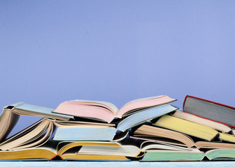 Open book, hardback colorful books on wooden table. Back to school. Copy space for text. Education business concept.