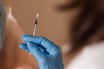 Syringe, medical injection in hand, palm or fingers. Medicine plastic vaccination equipment with needle. Nurse or doctor. Liquid drug or narcotic. Health care in hospital.