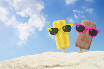 Couple ice cream wearing sunglasses on beach with copy space.