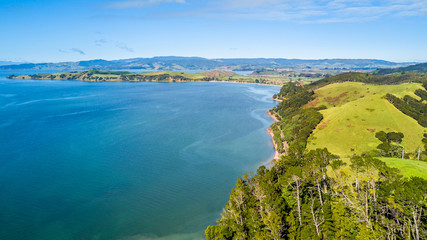 Aerial view on beautiful harbour with sunny beach and surrounding hillside, New Zealand