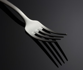 Fork on black background