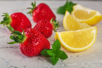 strawberry with lemony mint on white stone