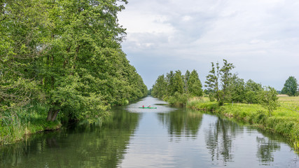 Fototapeta na wymiar Two people kayaking on a river