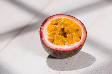 Half of passion fruit on wooden table.