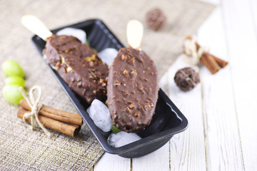 Dessert chocolate ice cream with nuts on wooden stick