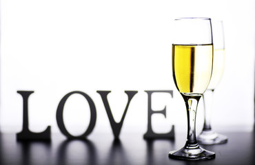 glass of white wine on a table on white background isolate