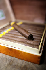 Large box of Cuban cigars on a wooden table