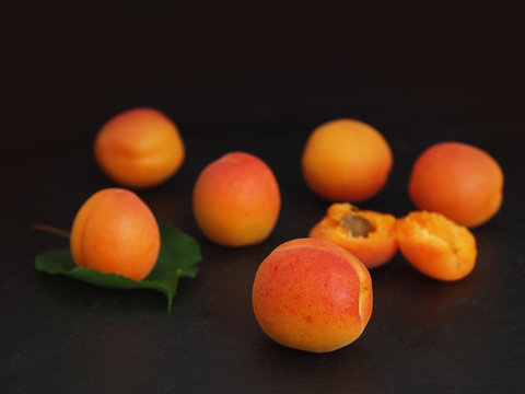 Apricot fruit on black background