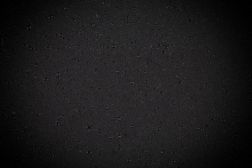 Water drops on dark stone