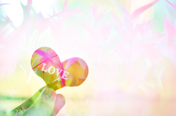 red heart with hand on the beach,select focus