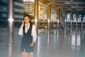 Fototapeta premium Asian pretty woman use smartphone at landmark bridge crossing in city.