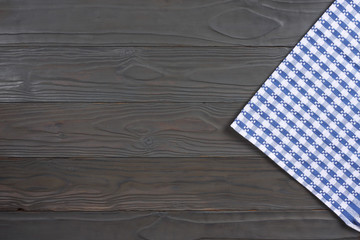 Obraz premium blue cloth on dark wooden background with copy space. Top view.