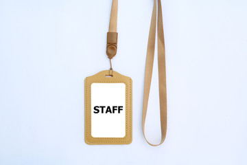 badge with text "STAFF" and brown ribbon on a white background.