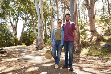 Obraz premium Portrait Of Couple Hiking Along Forest Path Together
