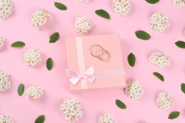 wedding rings on pink background. top view