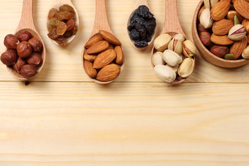 mix almonds, cashew nuts, hazelnut, peanuts, walnuts, pistachio in wood plate on wood background