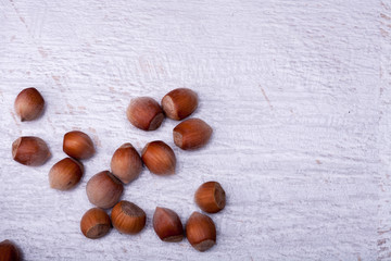 Hazelnuts on white wooden background in studio photo. Healhty snacks