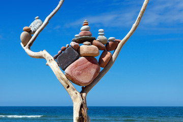 Balance and poise stones. Rock zen on the background of blue sky and sea