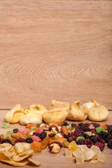 Mix of dried fruits on wooden background in studio photo. Healthy lifestyle