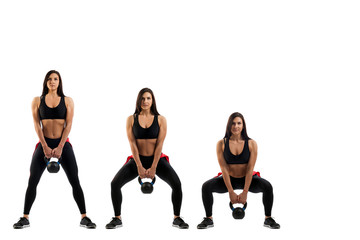 Obraz premium Squat with a weight on the buttocks of a slender young brunette on a white isolated background