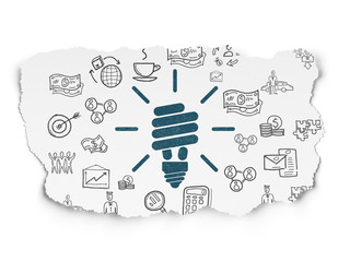 Business concept: Energy Saving Lamp on Torn Paper background
