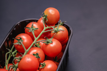 Cherry tomatoes in a plastic container.