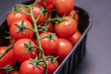 Cherry tomatoes in a plastic container.