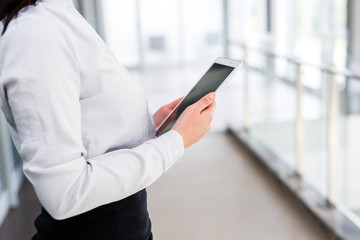 Modern business women holding tablet and toucing it