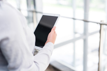 Modern business women holding tablet and toucing it