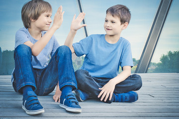 Two boys giving high five