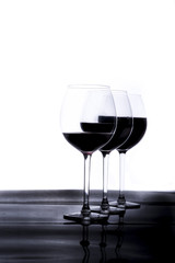 bottle and crystal glass with red wine, on white background